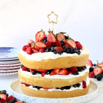 Three layers of sponge cake layered with fresh berries and whipped cream