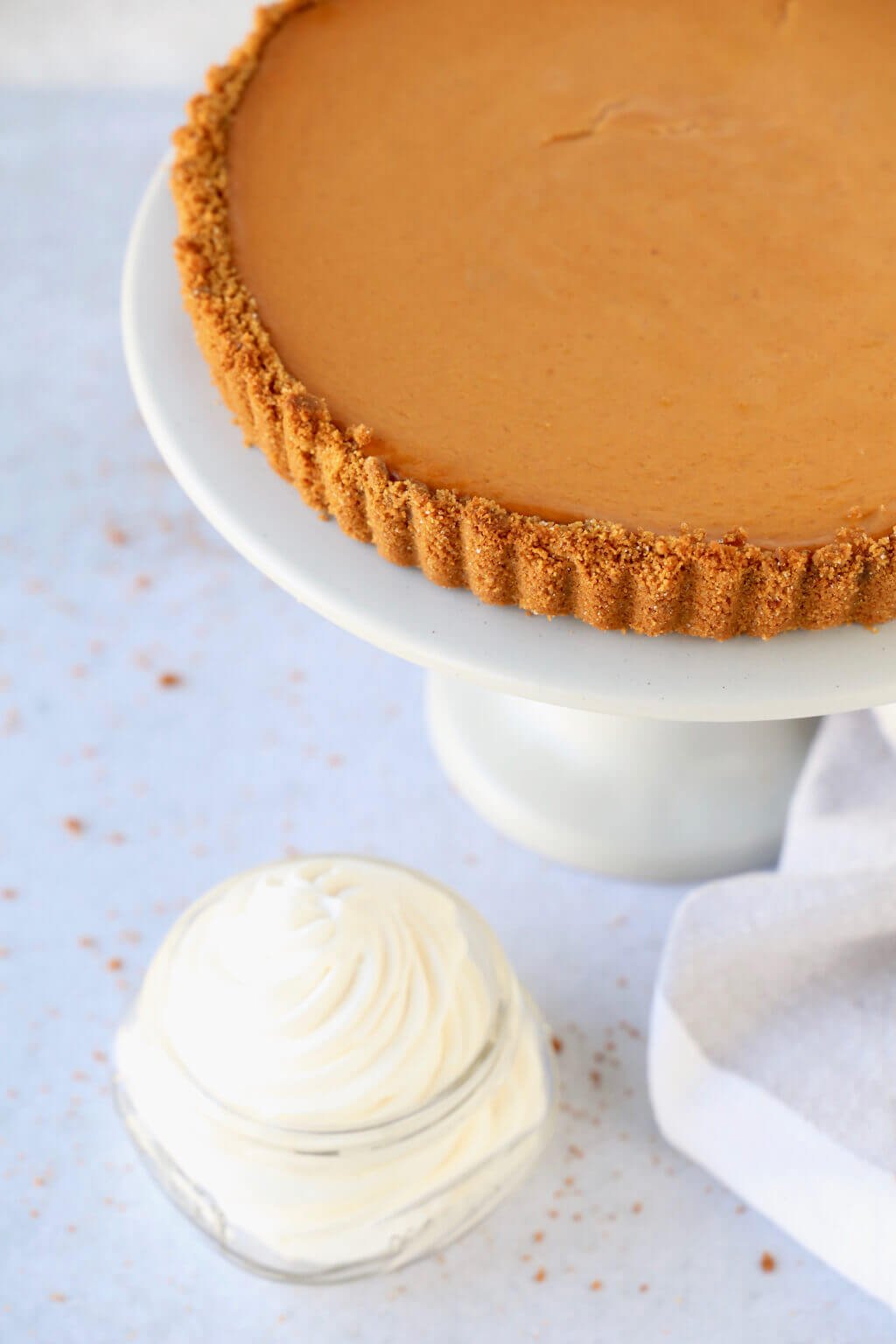 a close up of the pumpkin gingerbread tart and fresh whipped cream