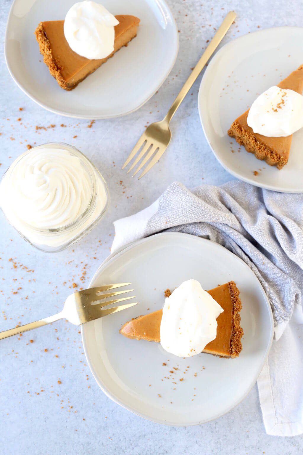 three slices of pumpkin gingerbread tart with fresh whipped cream 