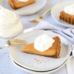 a slice of pumpkin gingerbread tart on a stack of plates