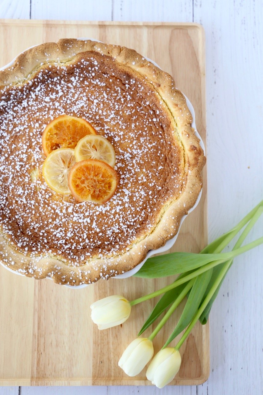 Close up of a garnished Easter Grain Pie  and three tulips