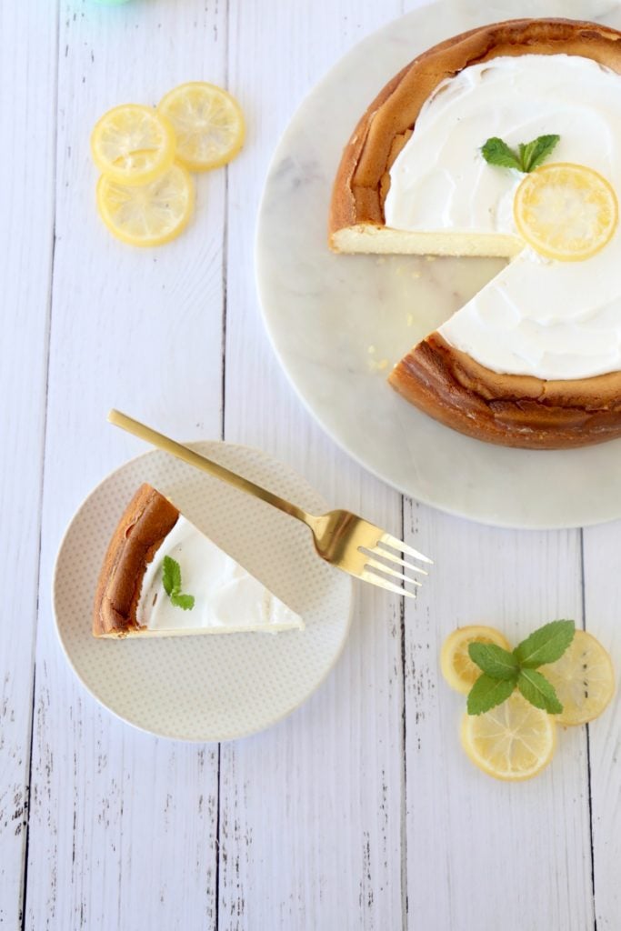 an overhead of a slice of cheesecake on a plate with a fork 