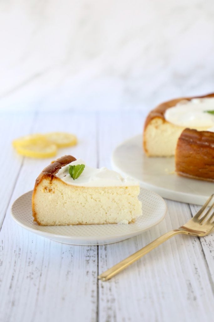 a slice of cheesecake on a plate with a fork next to it 