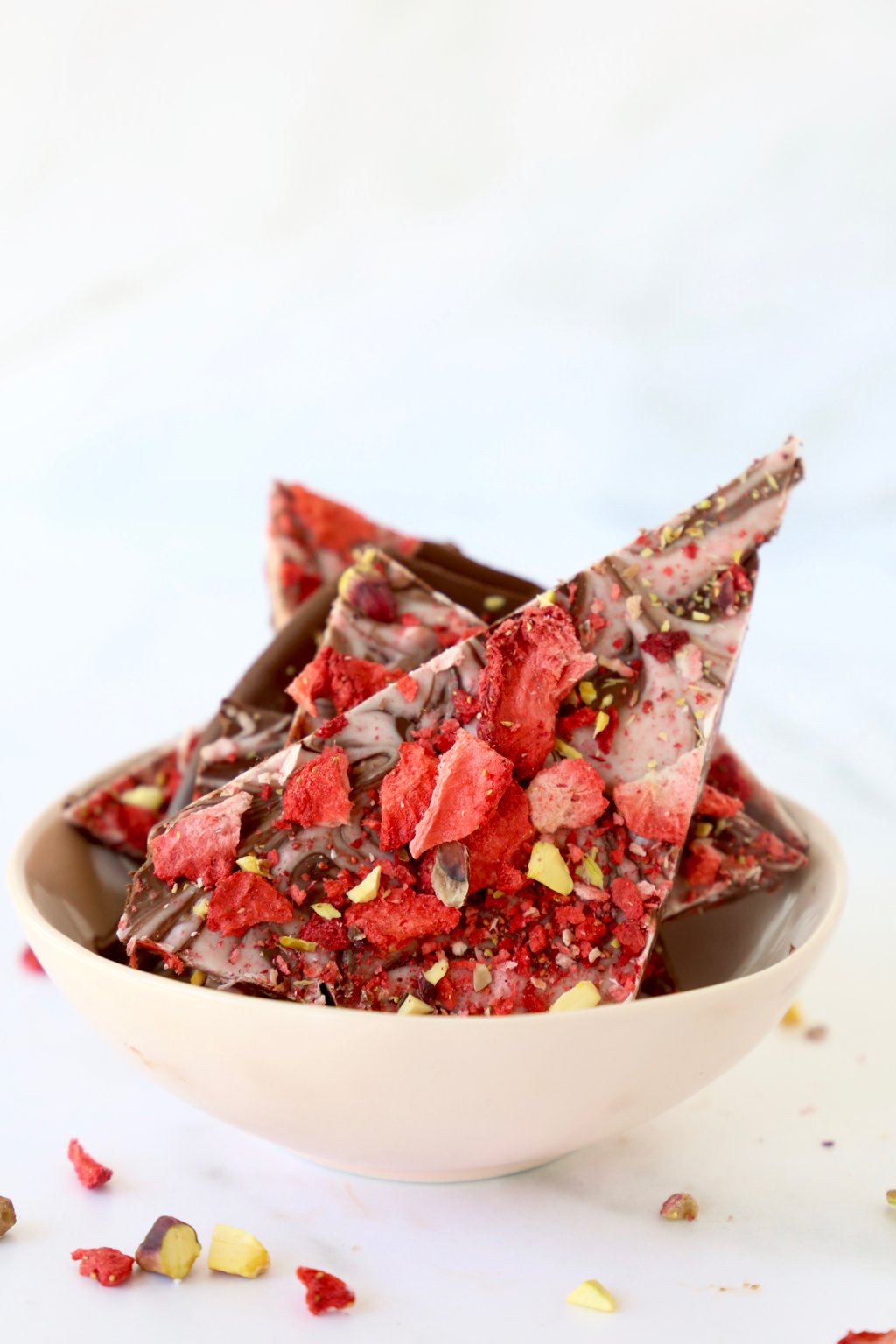Pieces of strawberry pistachio bark in a bowl