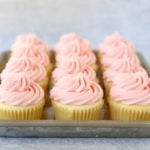 A tray of vanilla raspberry cupcakes
