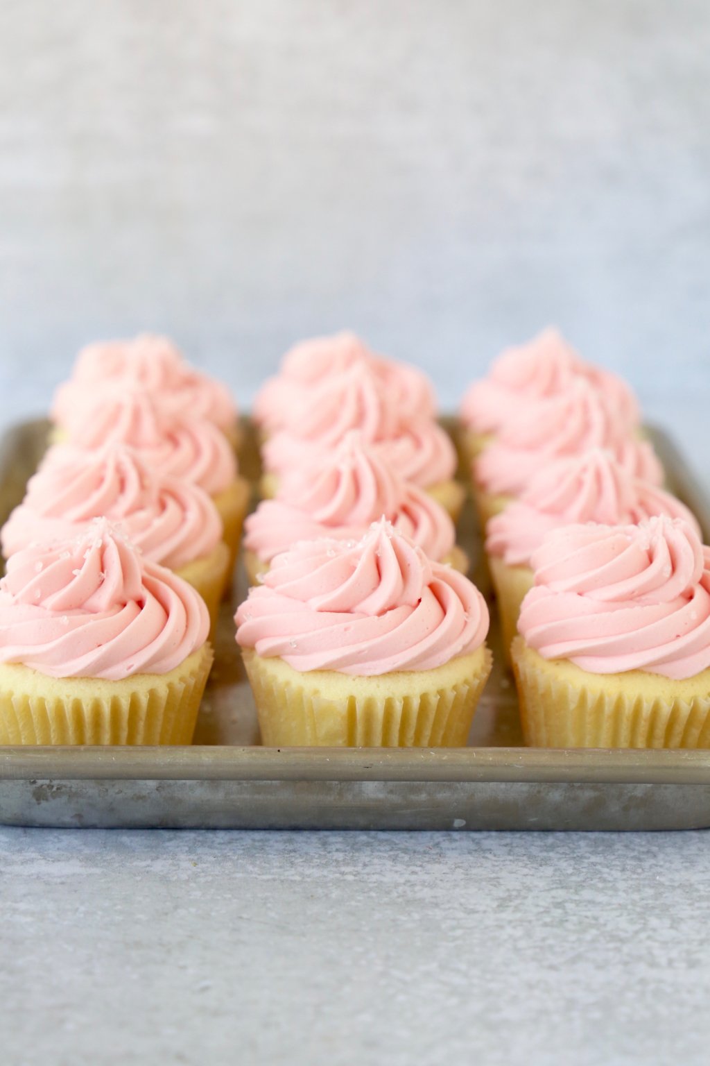 A tray of vanilla raspberry cupcakes 