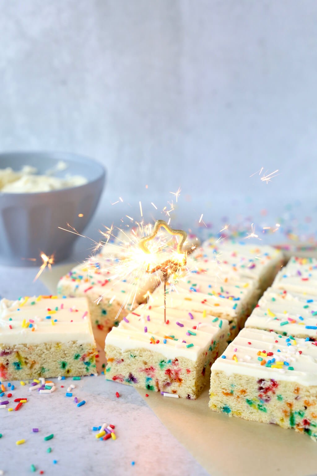 Sugar cookie bars with a star shaped candle burning in one