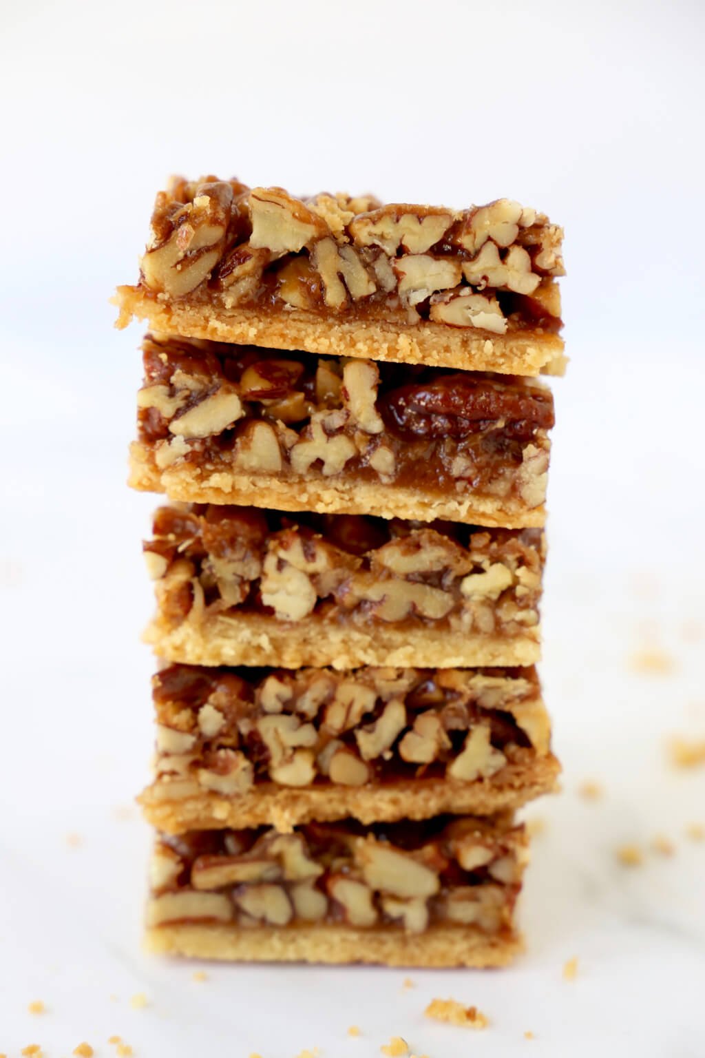 5 chewy pecan bars stacked on top of each other