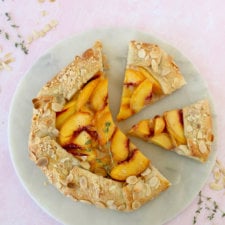 two slices cut out of a peach almond galette