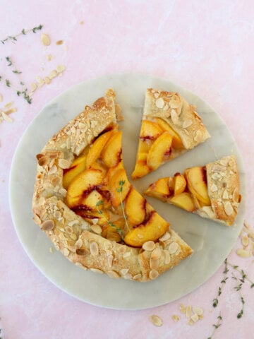 two slices cut out of a peach almond galette