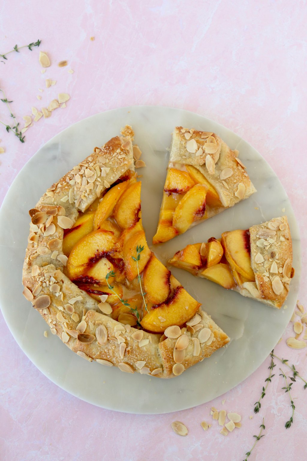 two slices cut out of a peach almond galette 