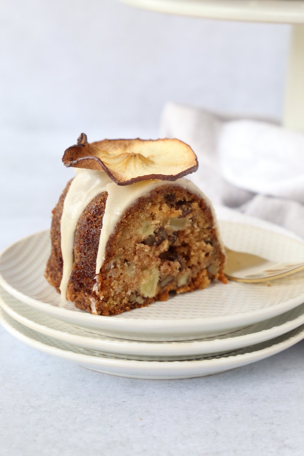 slice of apple spice bundt cake placed on a stack of plates