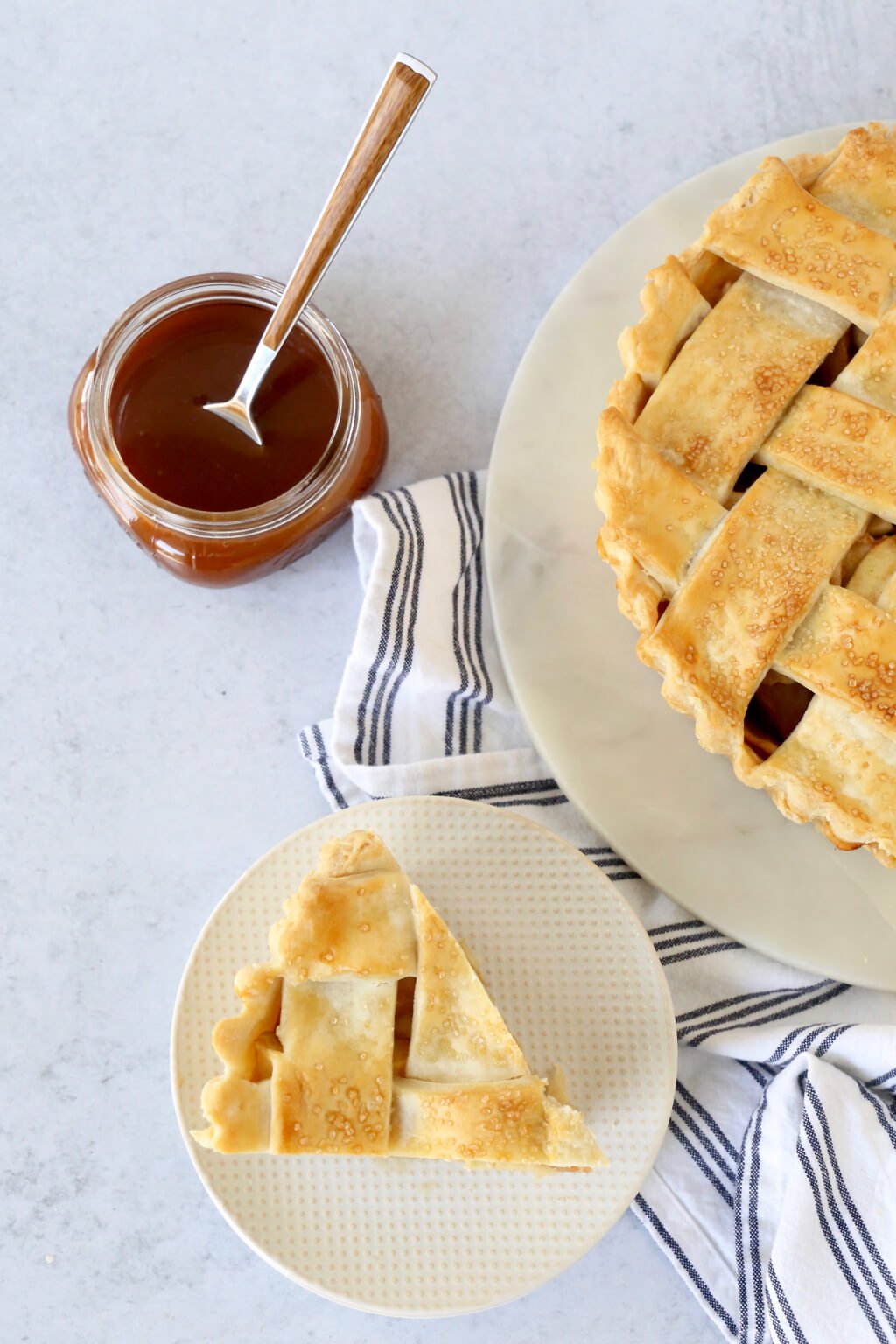 picture of one slice and the whole deep dish apple pie with caramel sauce 