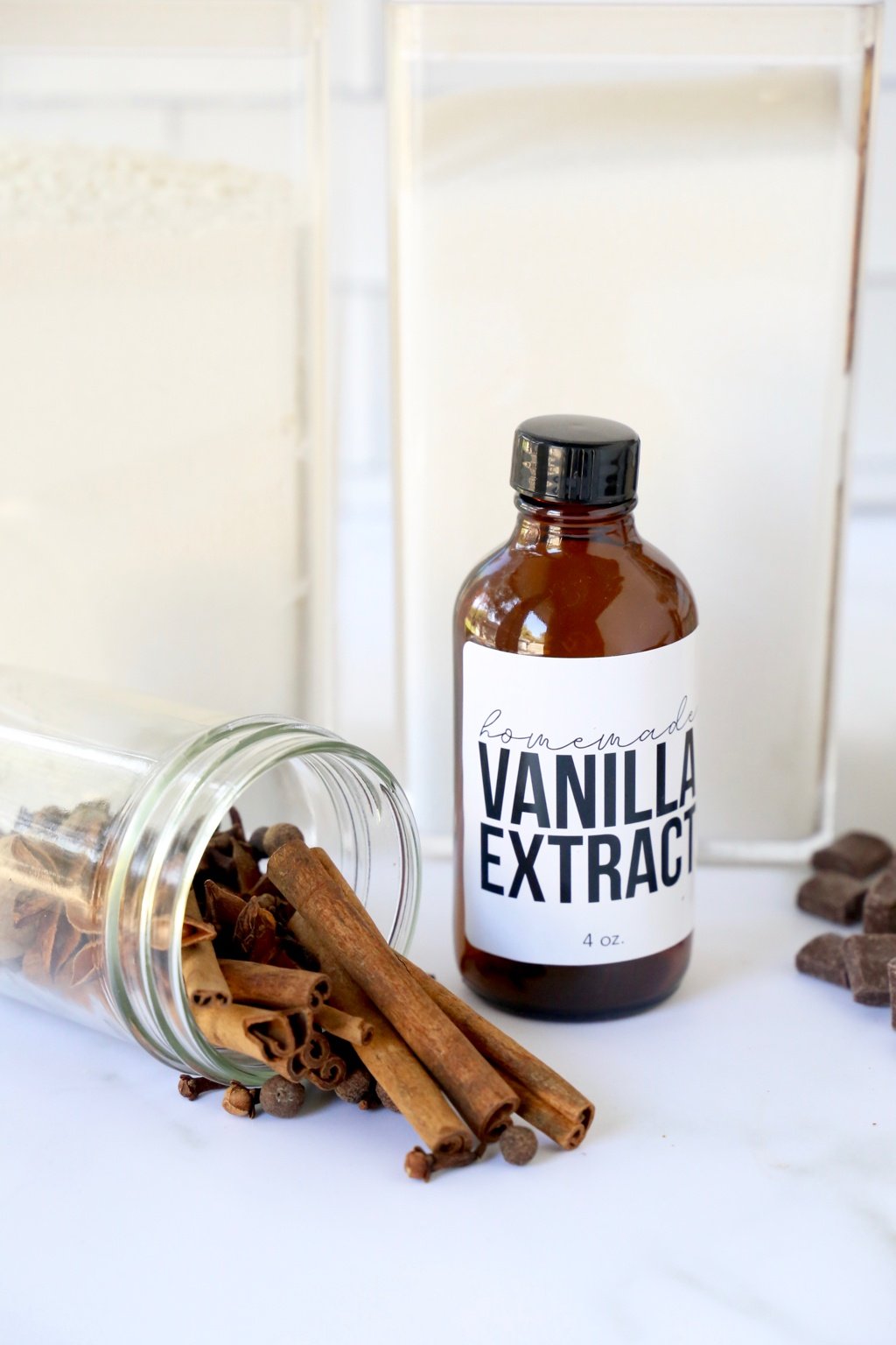 bottle of vanilla extract and a jar of spices 