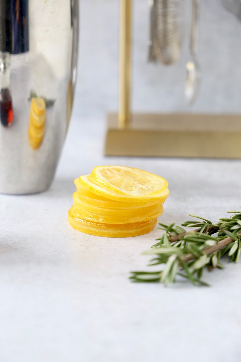 Sliced candied lemons and a sprig of rosemary