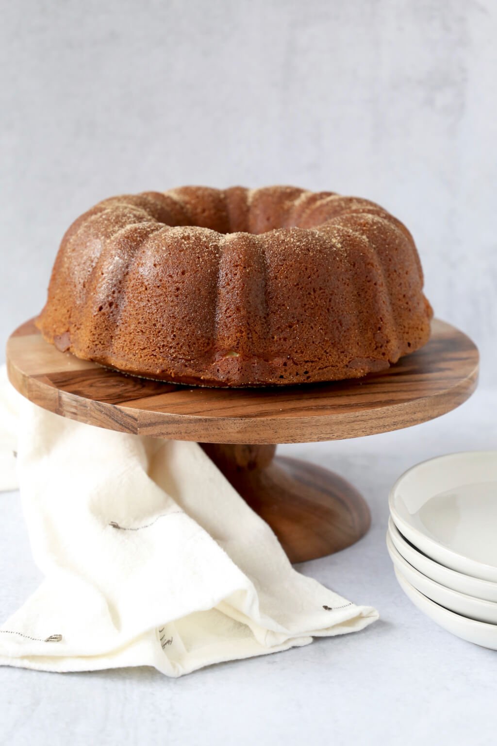 pumpkin bundt cake on a wood cake stand 