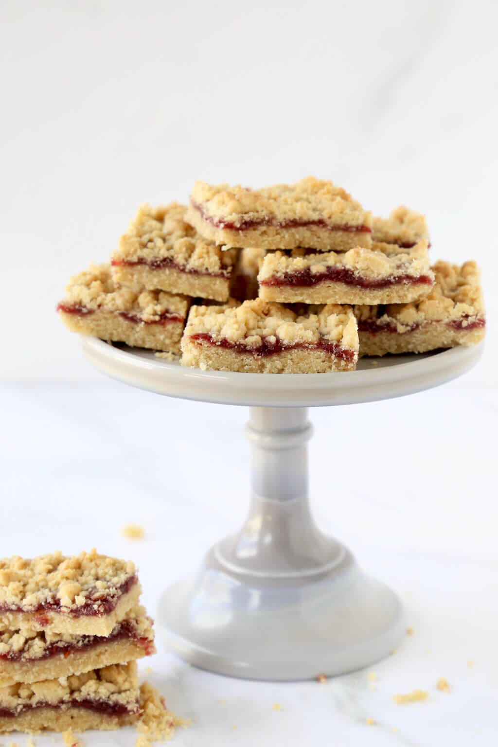 a cake stand of jam shortbread bars 