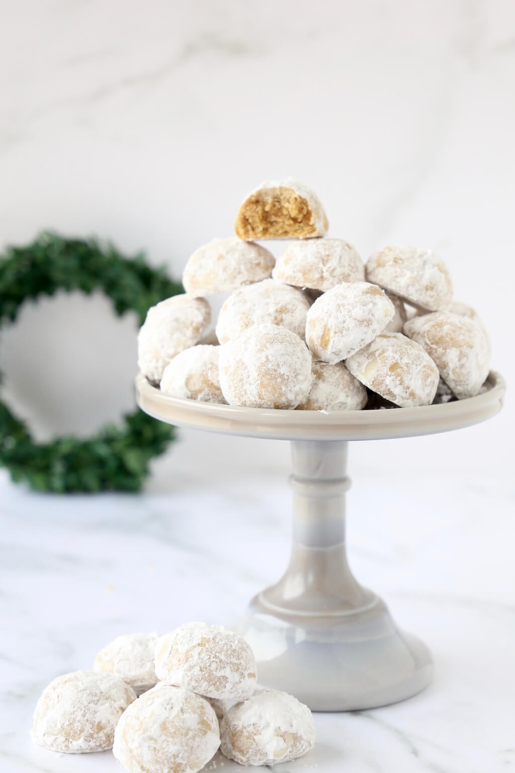 a pile of gingerbread cookies on a cake plate showing what the inside of the cookie looks like 