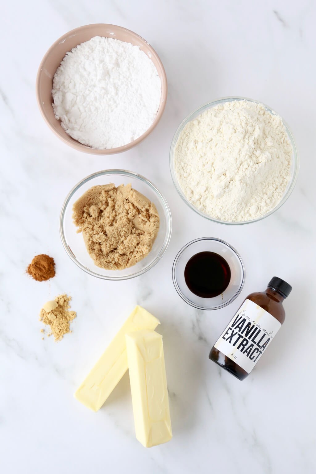 powdered sugar, flour, brown sugar, molasses, vanilla, spices and butter are prepped and ready to bake cookies