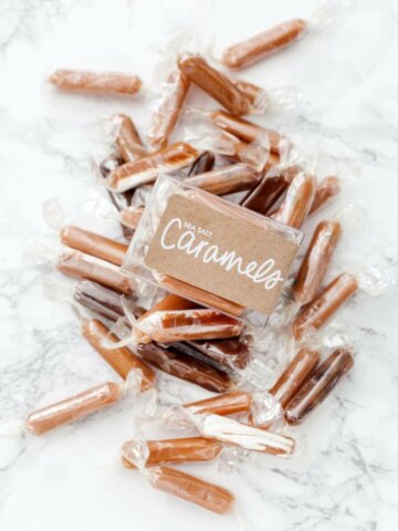 A box of sea salt caramel candy with caramels surrounding the box