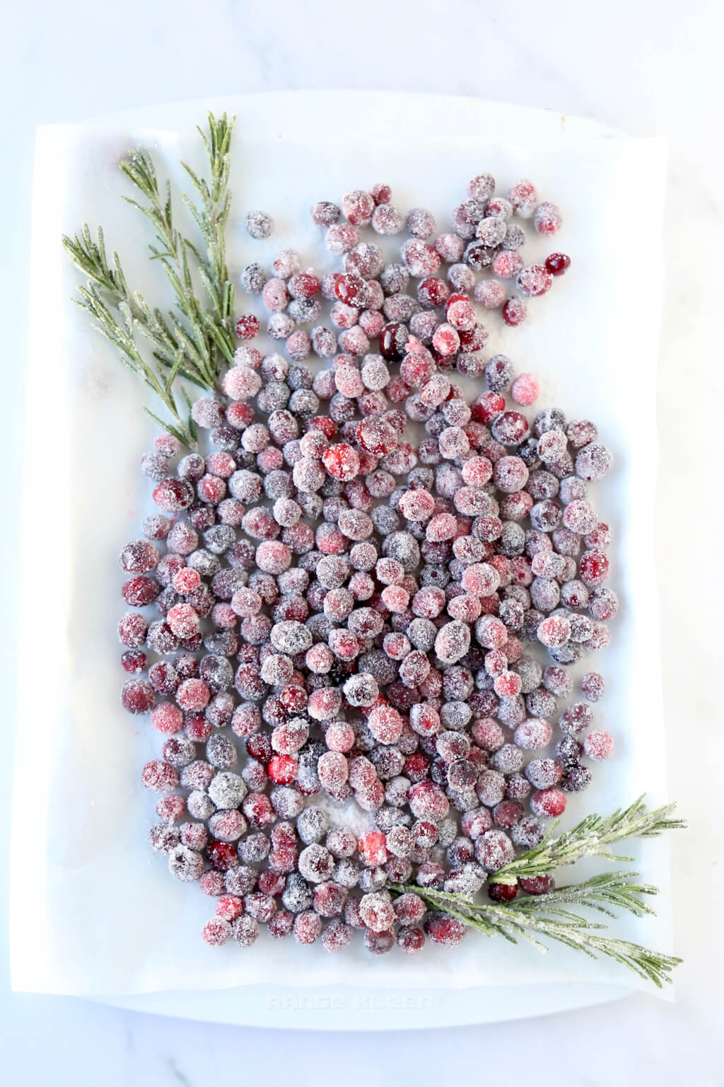 a tray full of sugared cranberries that are drying