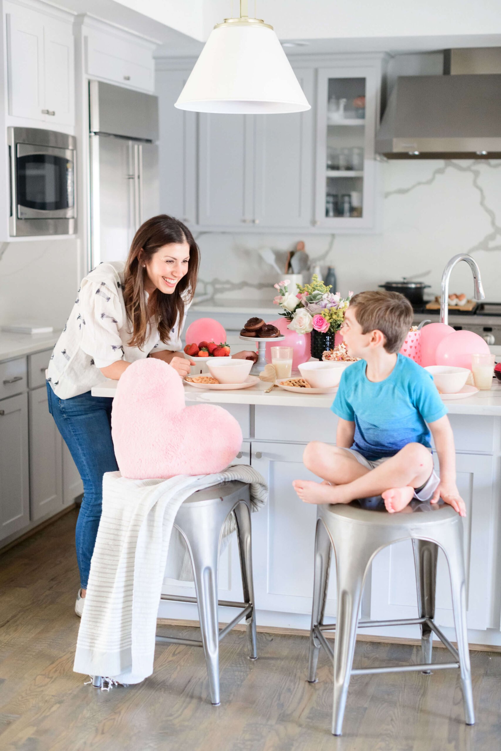 my son and I sitting at the counter with valentine's day decorations