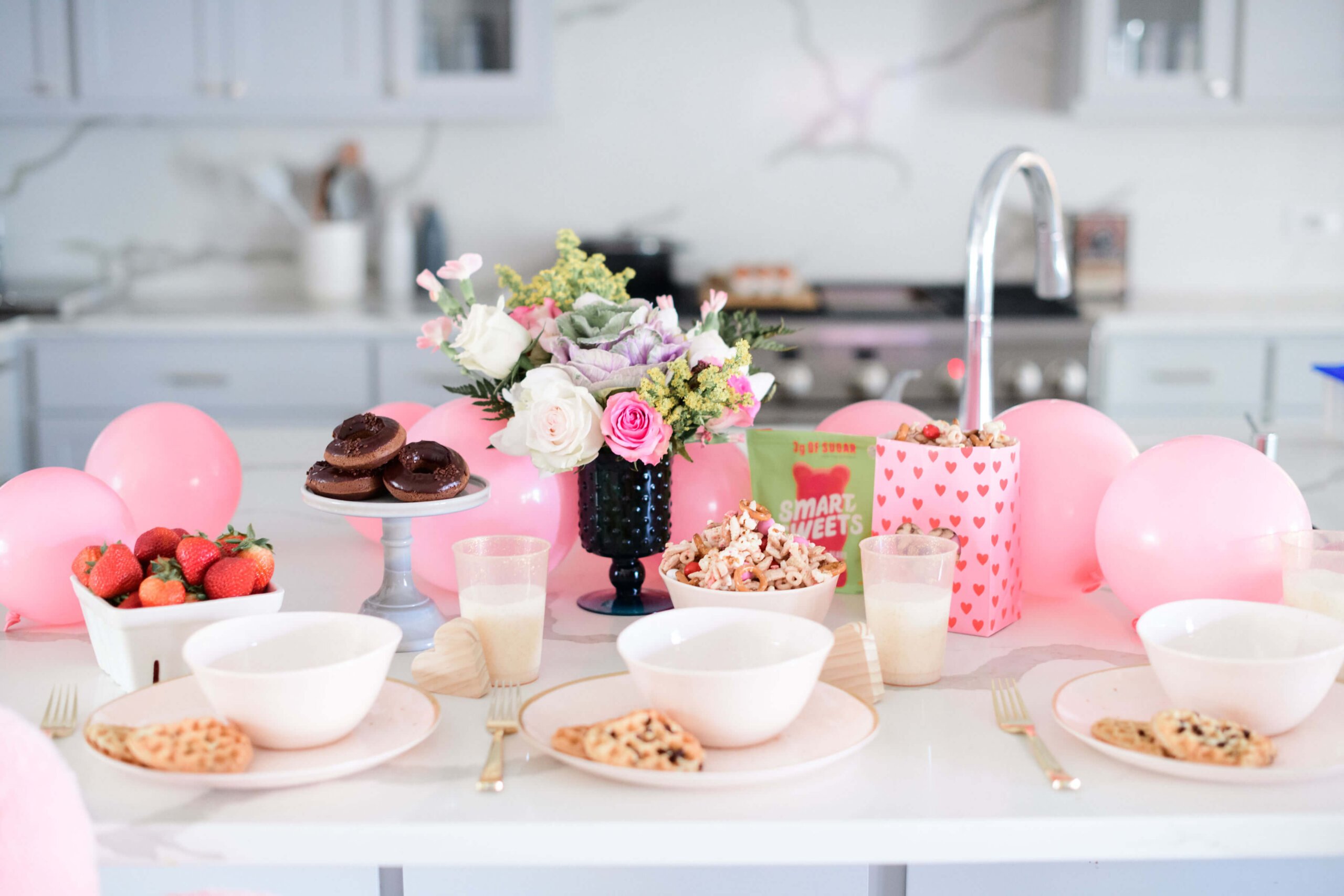 a tablescape of valentine's decorations, flowers and food 