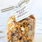 A clear bag of snack mix with a tailgate gift tag.