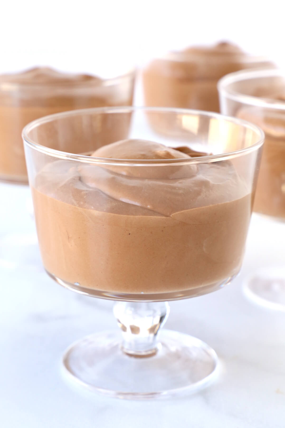 A glass bowl filled with chocolate mousse.