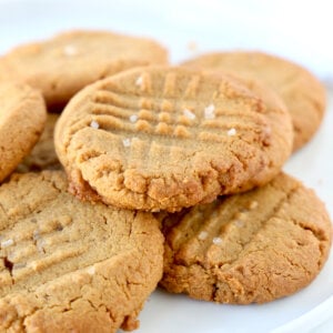 A white plate with cookies stacked.
