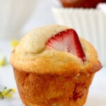 A muffin with a strawberry slice in it.