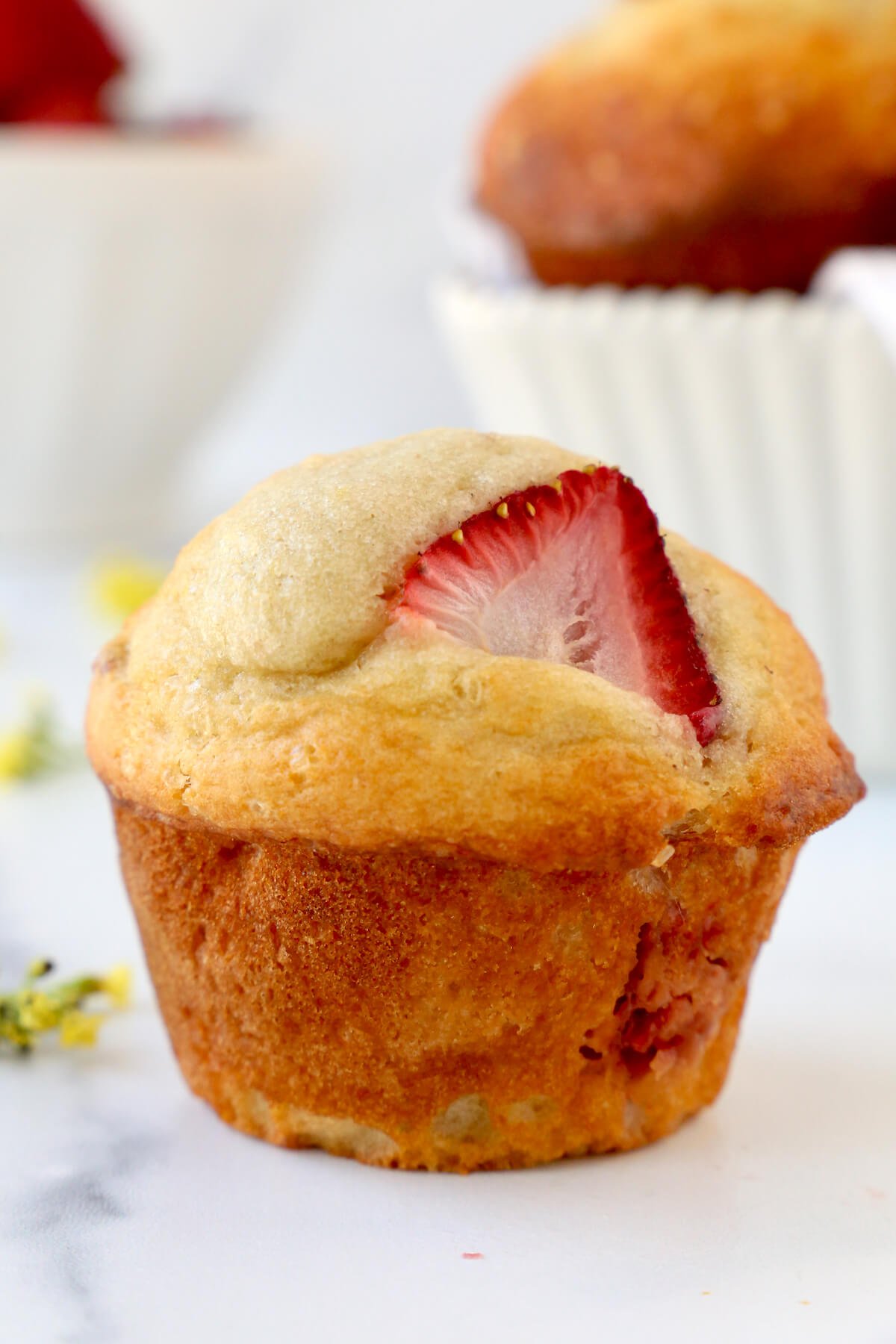 A muffin with a strawberry slice in it.  