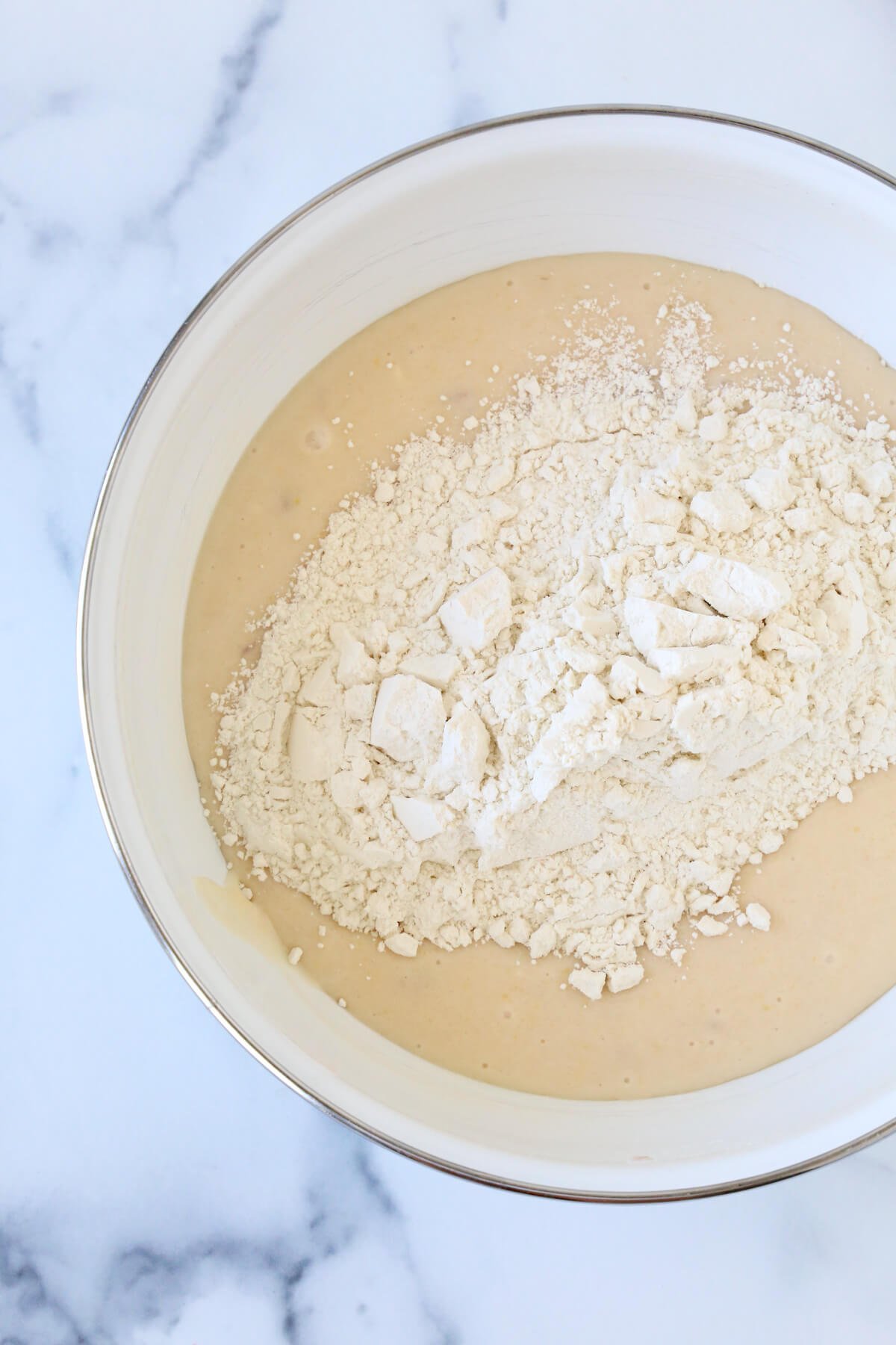 Batter in a bowl with flour on top.  