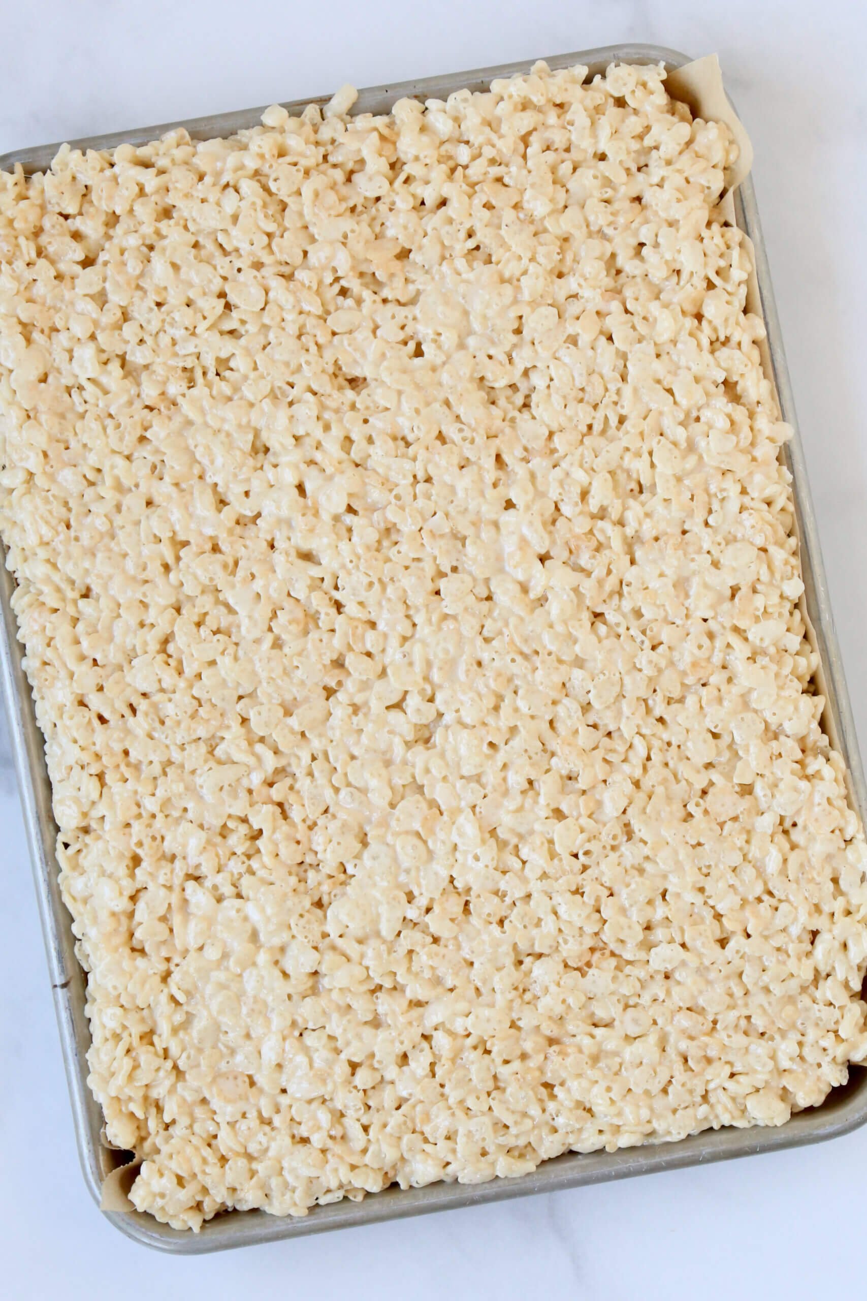 A rectangle tray of light brown rice krispie treats.